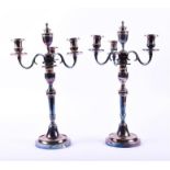 A pair of 20th century silver plated candelabra comprising three scrolled arms and a central