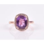An 18ct rose gold, diamond, and purple-pink colour-change sapphire ring the oval-cut sapphire of