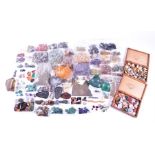 A quantity of loose raw and polished gemstones and minerals to include a small group of rings and