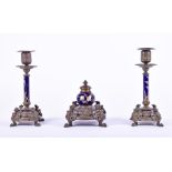 A late 19th century bronze and porcelain three piece desk set comprising a central inkwell and two