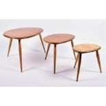 A 1970s set of three Ercol 'Pebble' blond elm and beech nesting side tables, model no.354,