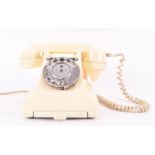 A mid-late 1950s GPO ivory telephone, model 328CB, with chrome dial, bell on and bell off buttons,