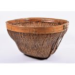A large and decorative woven reed basket of rounded square tapering form, possibly Indian or