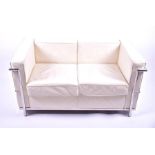 A late 20th century two seater sofa, upholstered in cream leather, with chromed tubular frame, after
