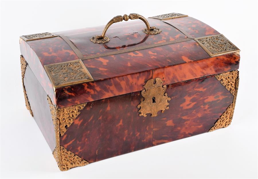 A large 18th century tortoiseshell chest of sarcophagus form with a hinged lid opening to reveal a