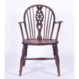 A 19th century small elm Windsor armchair with hoop back pierced splat, supported on turned feet