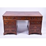 A late 19th century Chippendale style mahogany partners desk the top with carved shell and