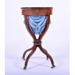 A French Empire period ormolu mounted burr amboyna sewing table circa 1820, the circular top opening