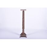 An English Victorian carved elm torchere the square top above a carved tapered spiral body with