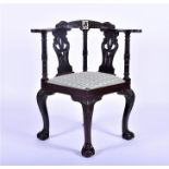 An Anglo-Chinese carved hardwood corner chair finely carved with scrolled foliage, the back