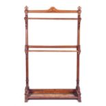 A late Victorian oak cloakroom stand carved with scrolling details, the moulded top centred with the