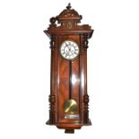 A Victorian mahogany Vienna wall clock the brass and enamel dial bearing Roman numerals, 118 cm.