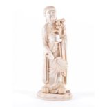 A large Japanese Meiji period carved ivory okimono in the form of a standing robed mage, holding