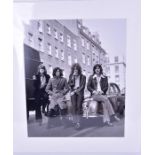 Led Zeppelin: a photograph from the negative showing the band in central London, sitting on a Jaguar