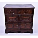 An 18th century oak chest with two short over two long drawers, moulded and fielded panelled