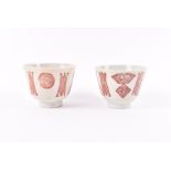 A pair of Chinese early Republic period porcelain cups designed with rouge de fer Shou and archaic