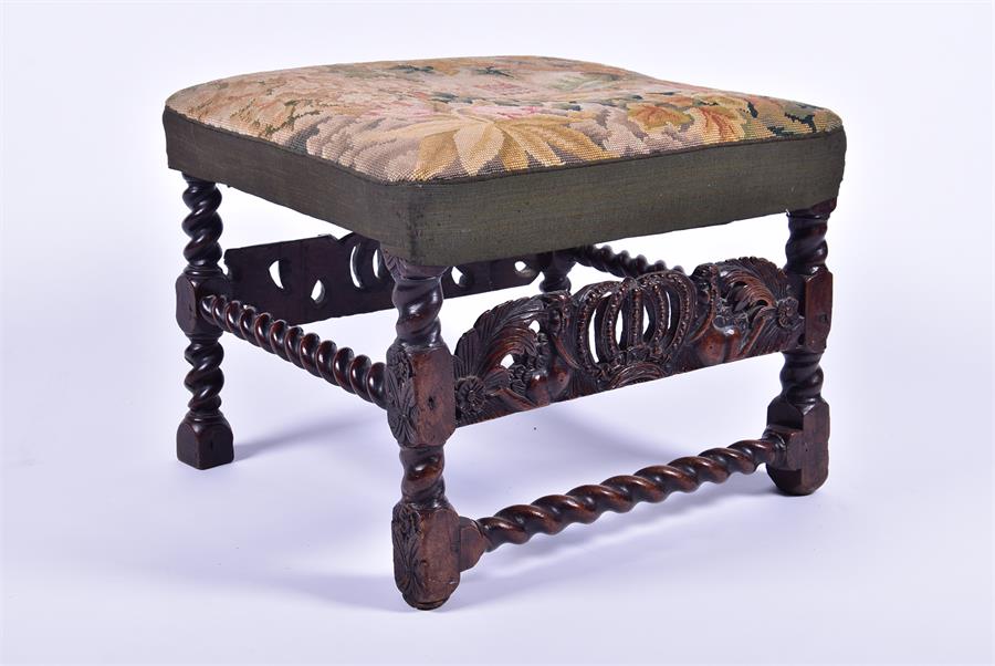 An 18th or early 19th century needlework stool the seat depicting a country house over a carved