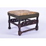 An 18th or early 19th century needlework stool the seat depicting a country house over a carved