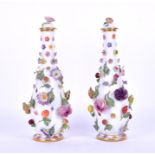 A pair of late 19th century Continental bottle vases and covers probably Meissen, with applied