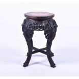 A 19th century Chinese hardwood jardiniere stand with inset circular pink veined marble top, the