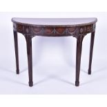 A late Victorian carved walnut demi lune table the top with leaf pattern rim above a frieze with