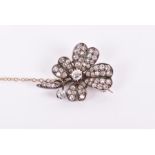 A Victorian diamond floral brooch the central old-cut diamond weighing approximately 0.26 carats,