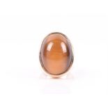 A yellow gold and tigers eye ring the large oval cabochon tigers eye inset into a straight-side