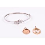 A 9ct white gold and cubic zirconium crossover bangle set with five graduated round-cut cubic