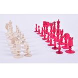 A mid-19th century English carved ivory chess set one side stained red, the King  8.1 cm high, the