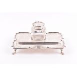 An Edwardian silver and cut glass inkstand by Mappin & Webb, Birmingham 1910, with shaped rim and