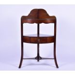 A late Victorian mahogany corner washstand with single drawer over an undertier, on outswept legs,