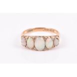 An 18ct yellow gold, diamond, and opal ring set with five graduated oval cabochon opals,