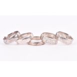 A group of five Victorian / early 20th century silver hinged bangles three filled, two hollow,