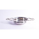 A large George II twin-handled silver strainer London, 1755 by Samuel Herbery & Co, the bowl pierced