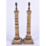 A pair of decorative early 20th century cut sectional onyx table lamps each turned pillar composed