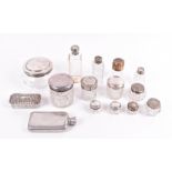 A collection of cut glass and silver topped bottles of various shapes and sizes, including powder