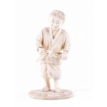A good Japanese Meiji period okimono in the form of a boy gathering leaves, 16 cm high, signed to