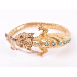 An unusual Chinese gilt metal and turquoise bracelet in the form of a mythological creature with red