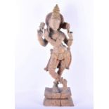 A large late 19th / early 20th century stripped carved wooden figure of Vishnu the figure with