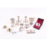 A group of silver items including a cream jug, a boxed napkin ring, a loose napkin ring, a silver