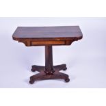 A 19th century Rosewood fold-over card table on an inverted tapering column and quatrefoil base,