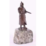 An early 20th century German bronze study of a First World War soldier the figure standing in a long