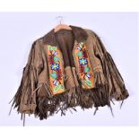 A Sioux Indian animal skin jacket with applied beadwork, early 20th century, 71 cm in length.