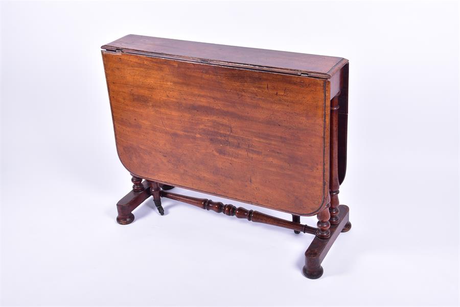 A 19th century mahogany Sutherland table on turned legs supported on block and bun feet, 91 cm