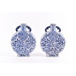 A pair of Chinese blue and white moon flask vases modelled with phoenixes and floral patterns