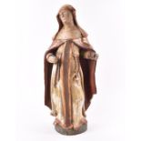 An 18th century-style carved wood polychrome figure of a nun standing on a circular base, 53 cm