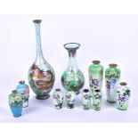A collection of eleven early 20th century Japanese cloisonne vases of varying forms to include three