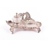 A Victorian silver rococo style inkstand by Thomas Glaser, London 1893, designed with a relief