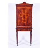 A 19th century rosewood cabinet on an associated stand with domed arch pediment over a single