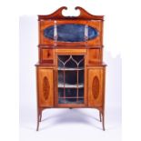 An Edwardian mahogany and inlaid display cabinet with broken scroll pediment over a mirrored top,